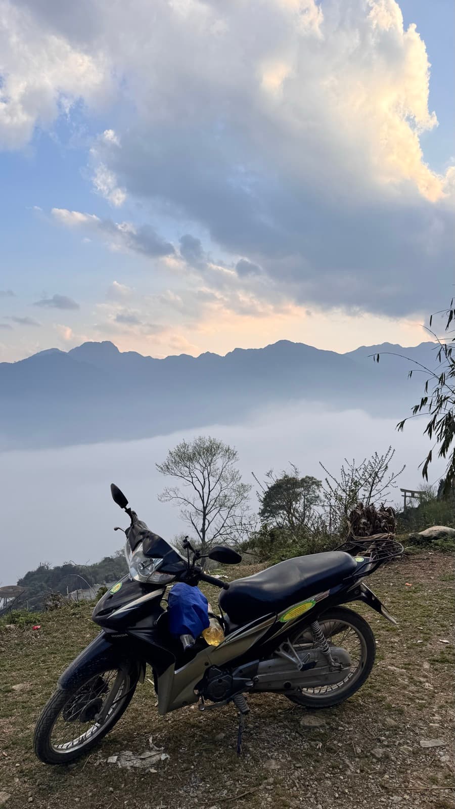 Loaded motorbike resting above a sea of clouds
