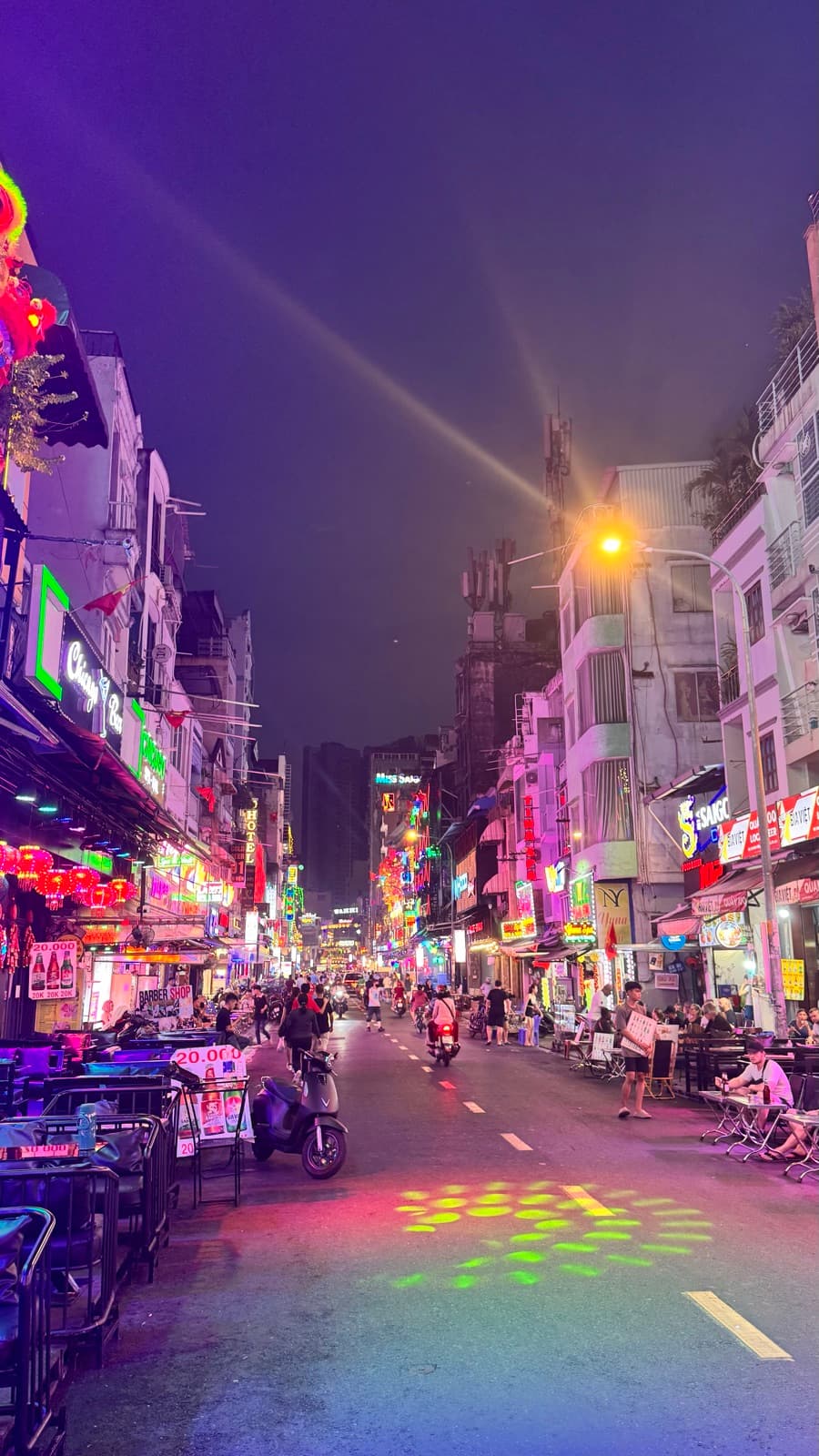 Neon-lit nightlife street in Saigon