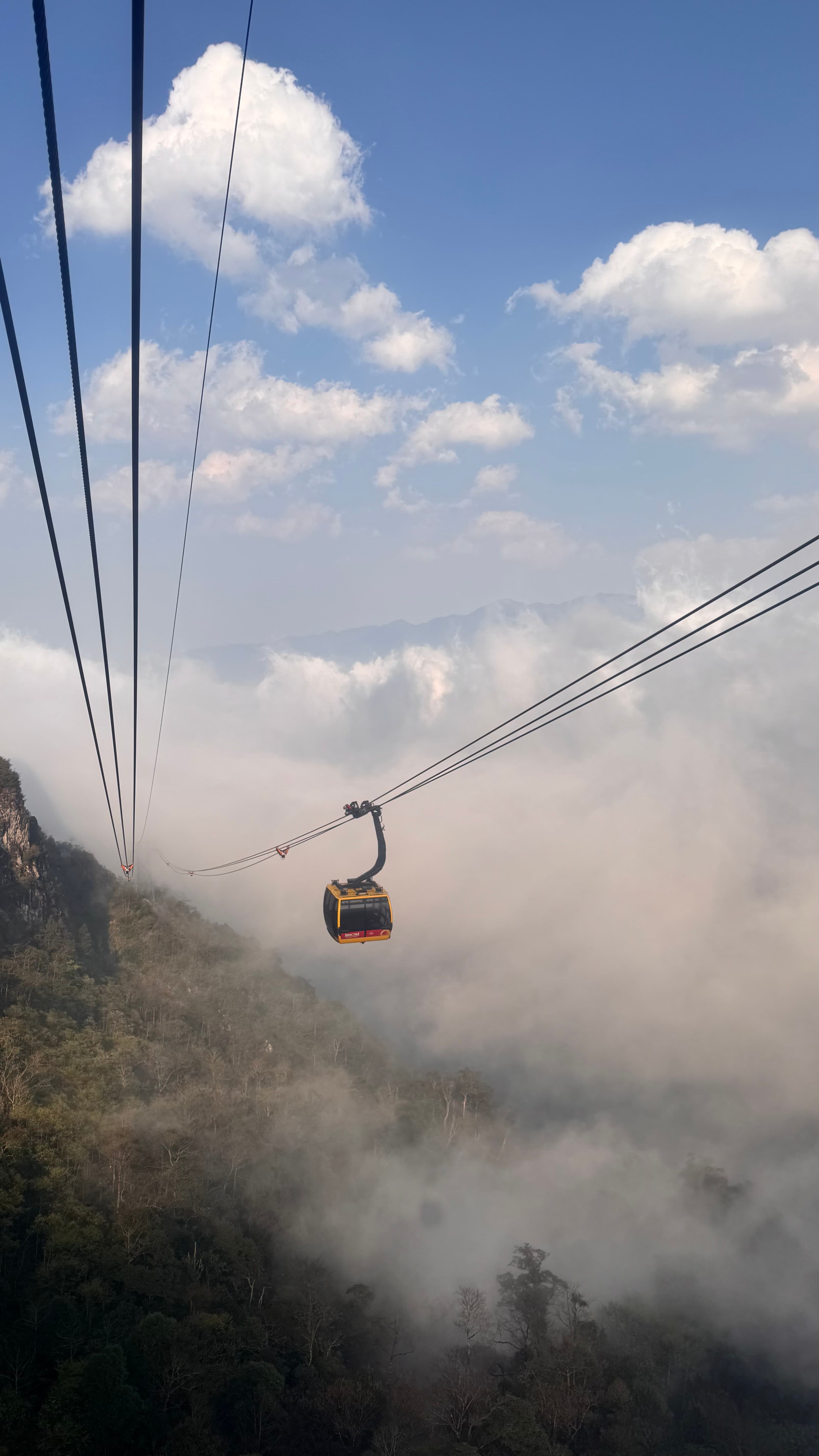 A cable car gliding above the clouds toward Fansipan in Sa Pa